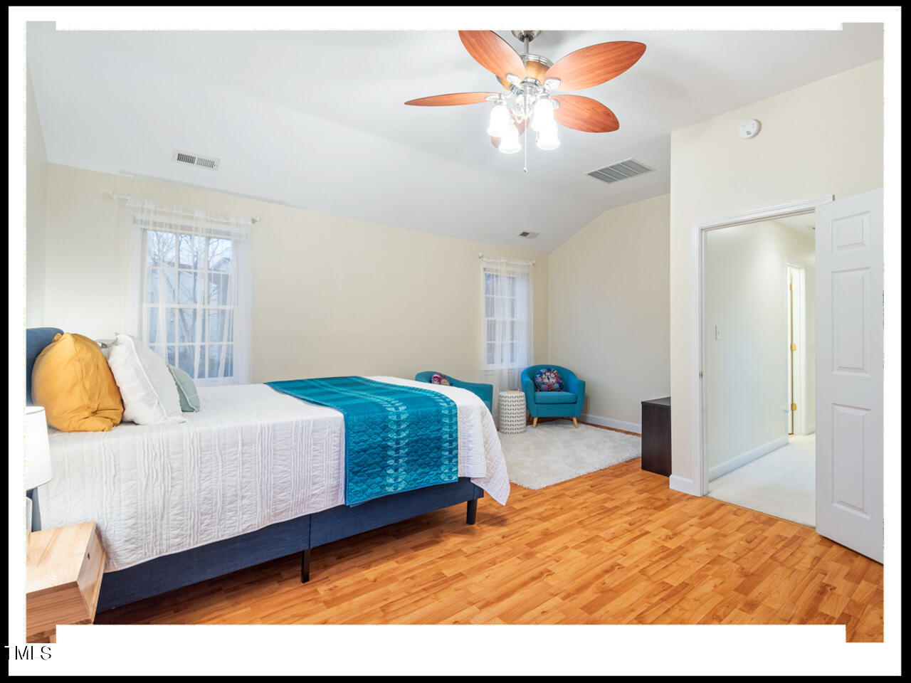 8214 Morrell Lane Durham, NC 27713 - Photo 33 of 48 a bedroom with a bed and a chandelier