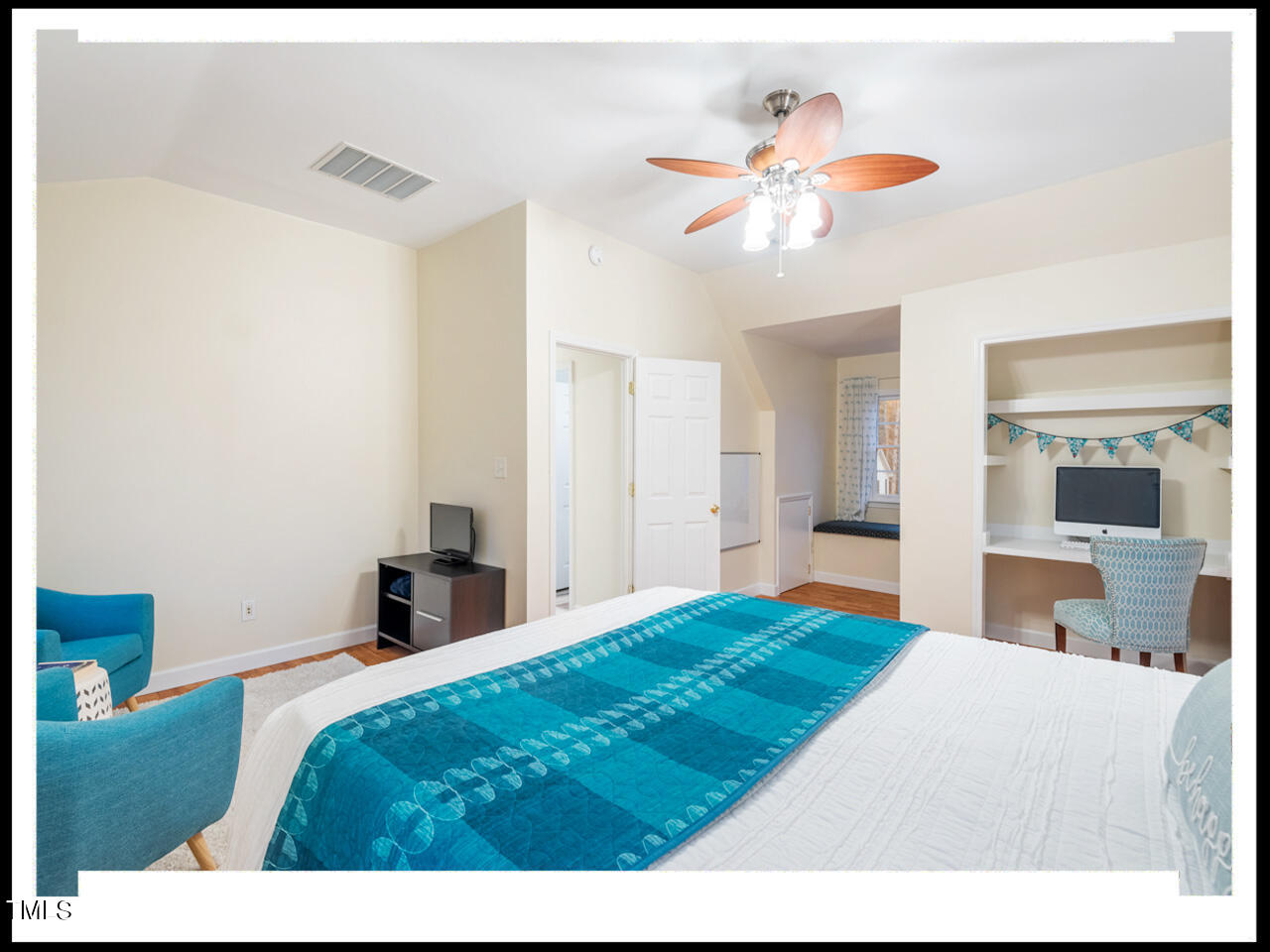 8214 Morrell Lane Durham, NC 27713 - Photo 34 of 48 a bedroom with a bed and a chandelier