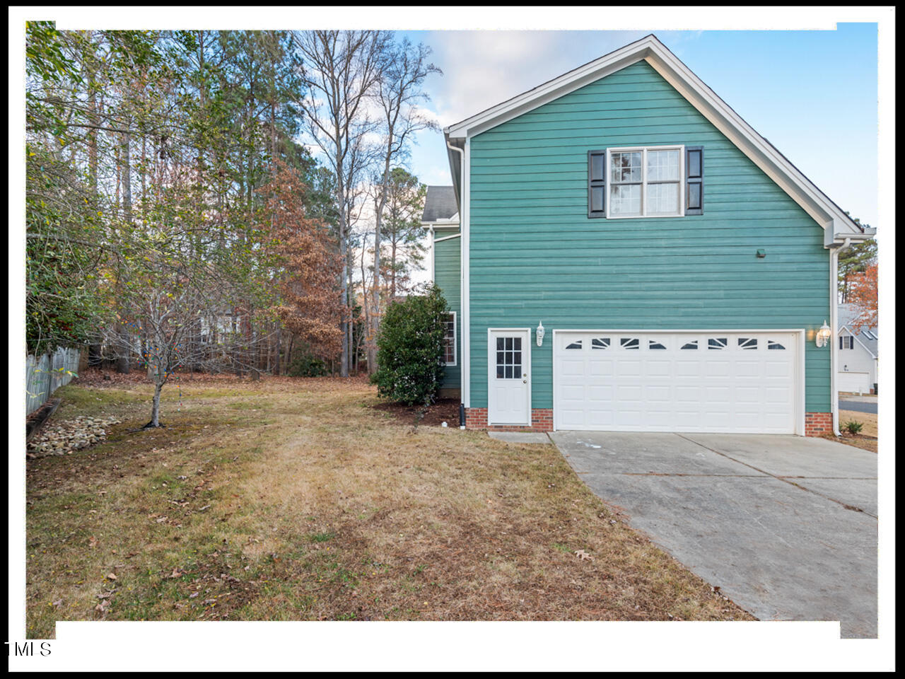 8214 Morrell Lane Durham, NC 27713 - Photo 46 of 48 a view of a house with a yard and garage