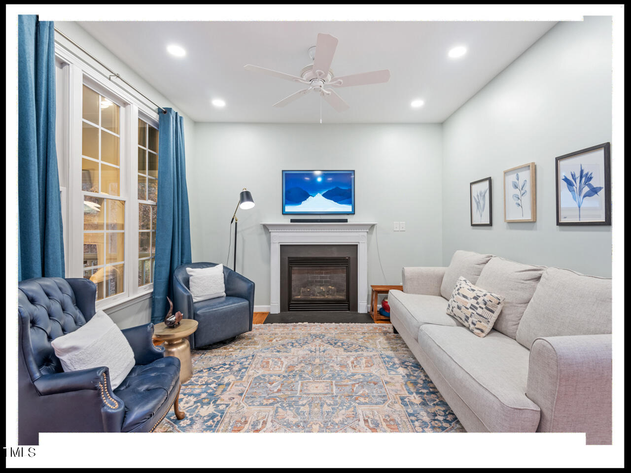 8214 Morrell Lane Durham, NC 27713 - Photo 9 of 48 a living room with furniture a rug and a fireplace