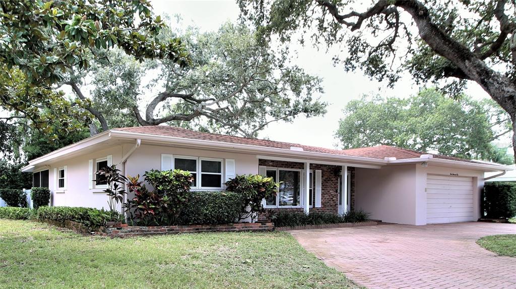 a front view of house with a garden