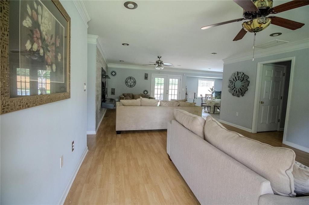 4184 Red Laurel Way Southwest Snellville, GA 30039 - Photo 14 of 35 a living room with furniture and a chandelier