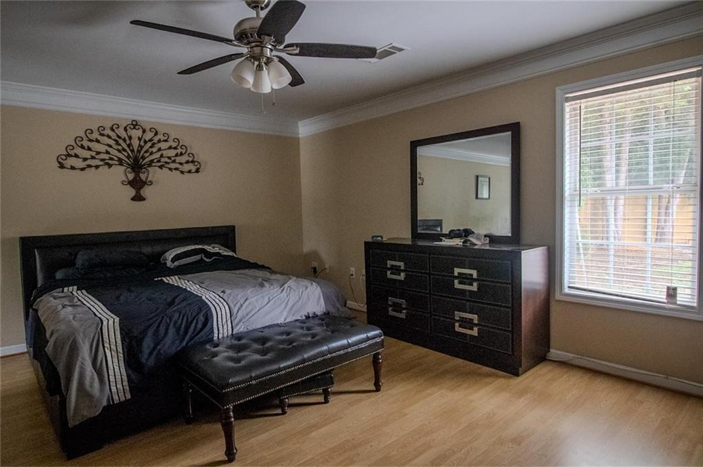 4184 Red Laurel Way Southwest Snellville, GA 30039 - Photo 26 of 35 a bedroom with a bed and wooden floor