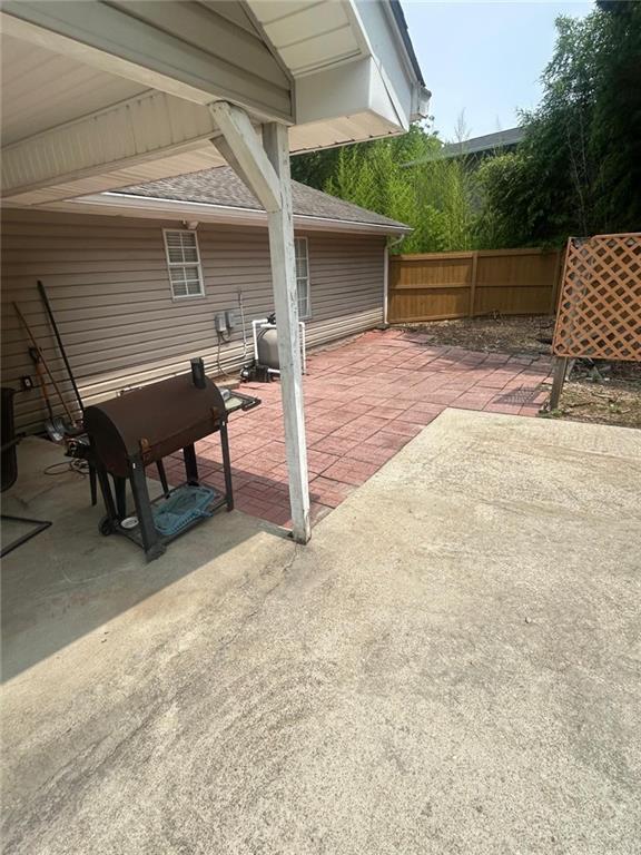 4184 Red Laurel Way Southwest Snellville, GA 30039 - Photo 31 of 35 a view of a deck with table and chairs with wooden floor and fence