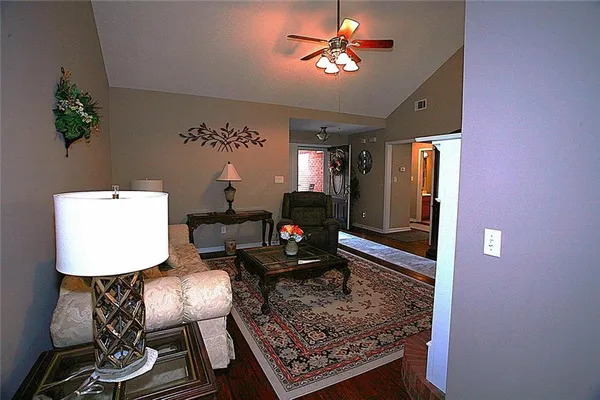 a living room with furniture and a chandelier
