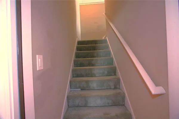 a view of staircase with white walls