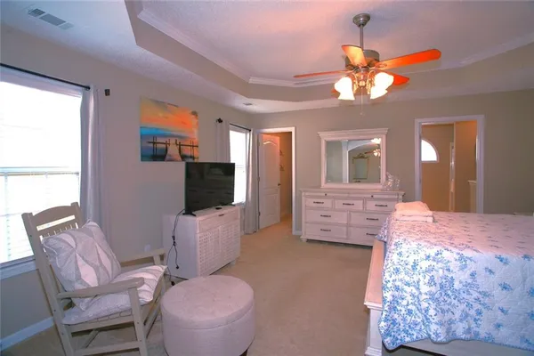 a bedroom with furniture and a flat screen tv