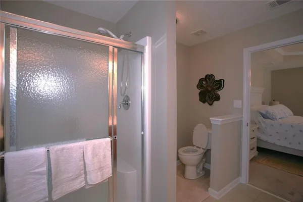 a bathroom with a toilet and a shower