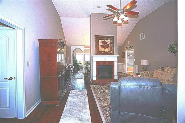 a view of a livingroom with furniture and chandelier fan