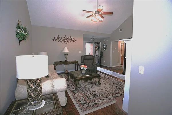 a living room with furniture and a chandelier