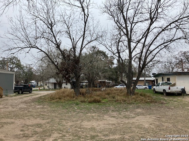 406 Patrick Avenue Pleasanton, TX 78064 - Photo 4 of 18 a view of a yard with a snow on the road