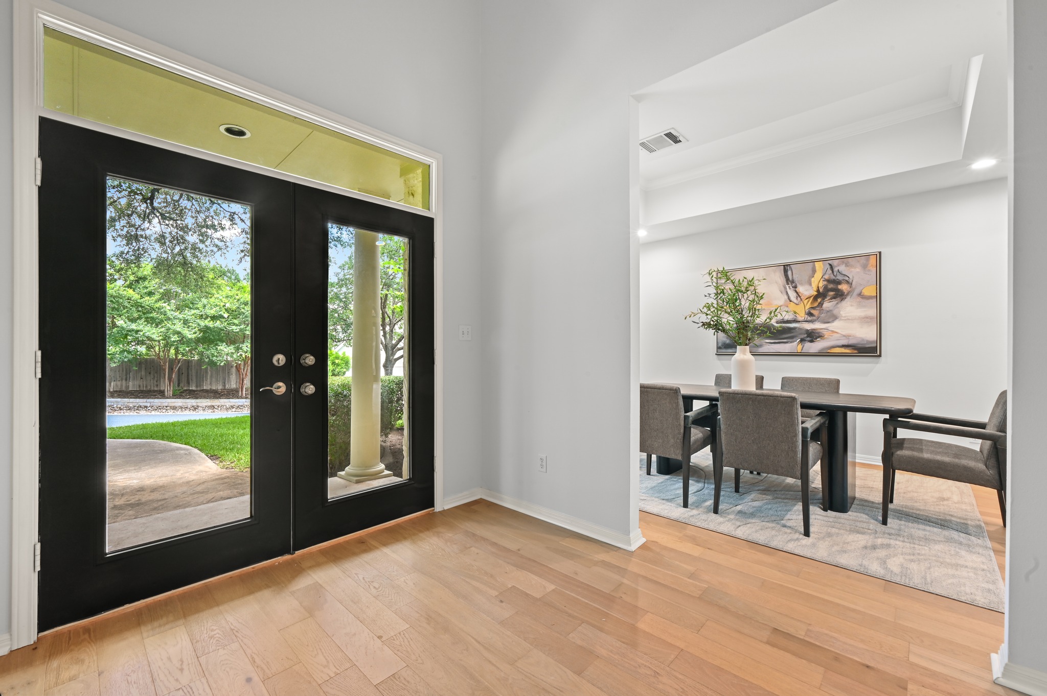 1107 Bowie Road Austin, TX 78733 - Photo 5 of 40 Enter through a grand double-door entrance into this bright and airy foyer with rich hardwood flooring.