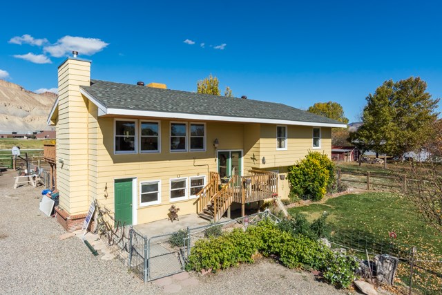 3476 F Road Clifton, CO 81520 - Photo 1 of 29 a front view of a house with a yard