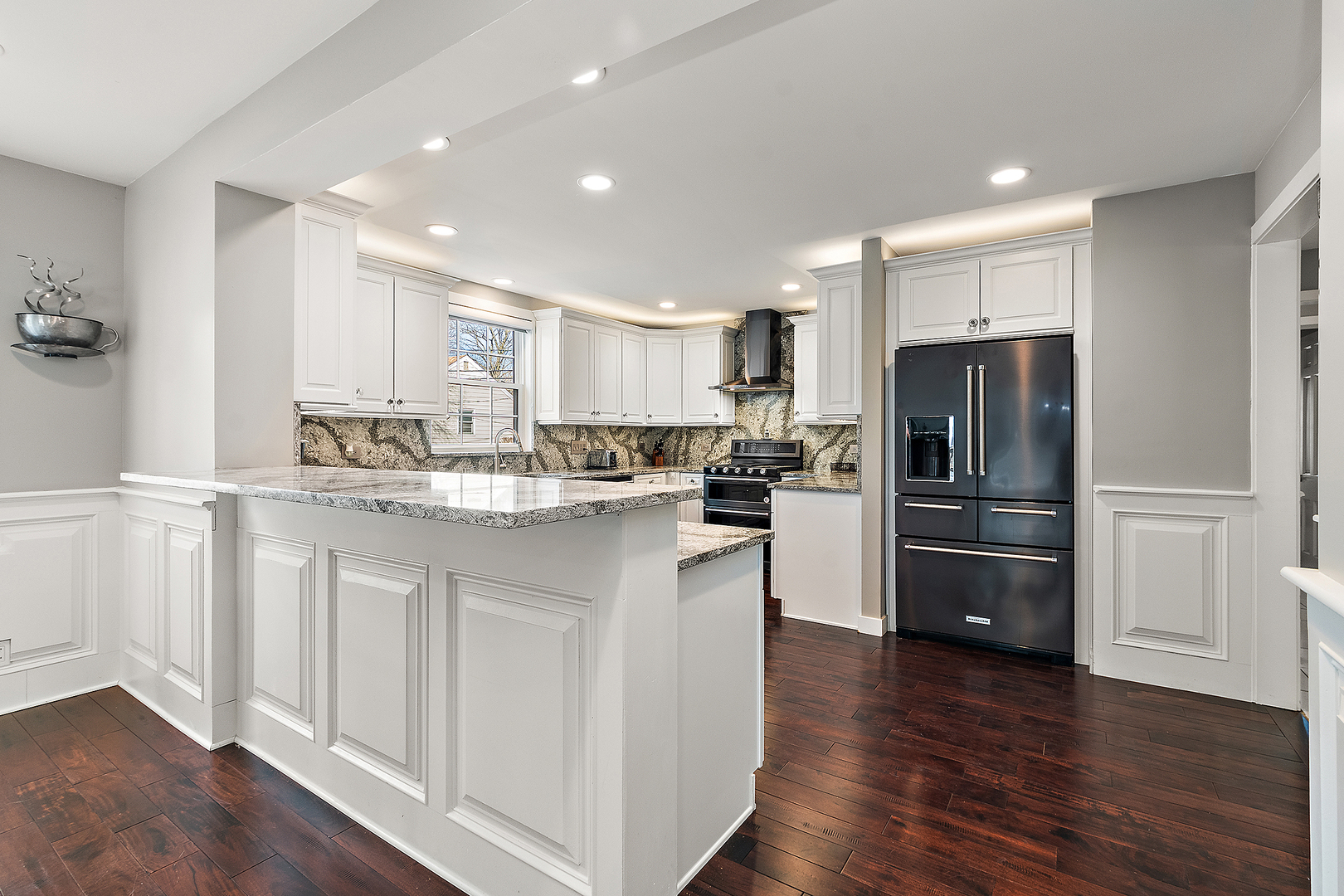 305 North Reed Street Joliet, IL 60435 - Photo 14 of 62 a kitchen with kitchen island white cabinets and stainless steel appliances