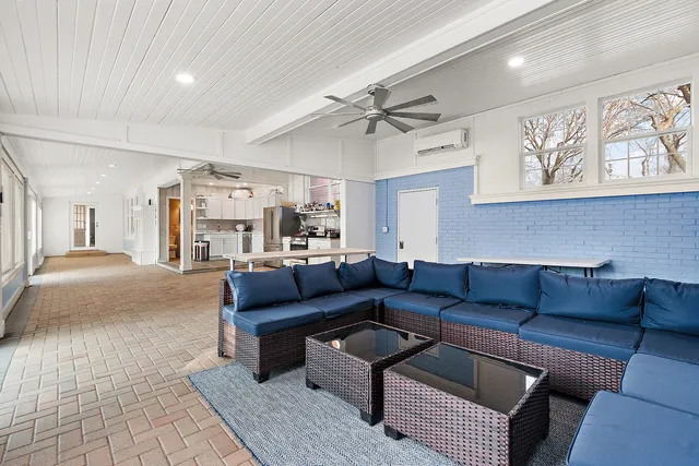 a view of a workspace with furniture and wooden floor