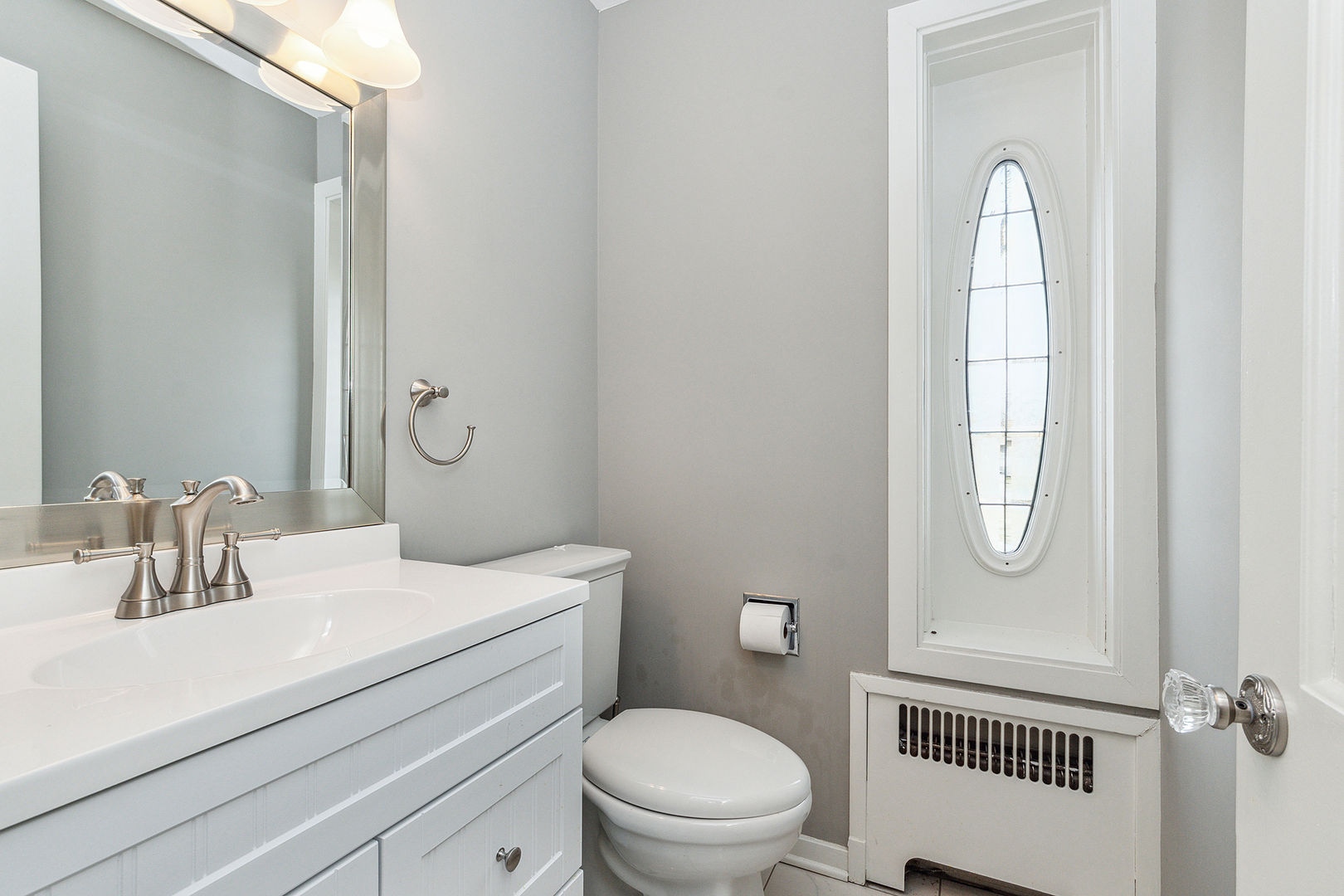 305 North Reed Street Joliet, IL 60435 - Photo 28 of 62 a bathroom with a toilet a sink and mirror