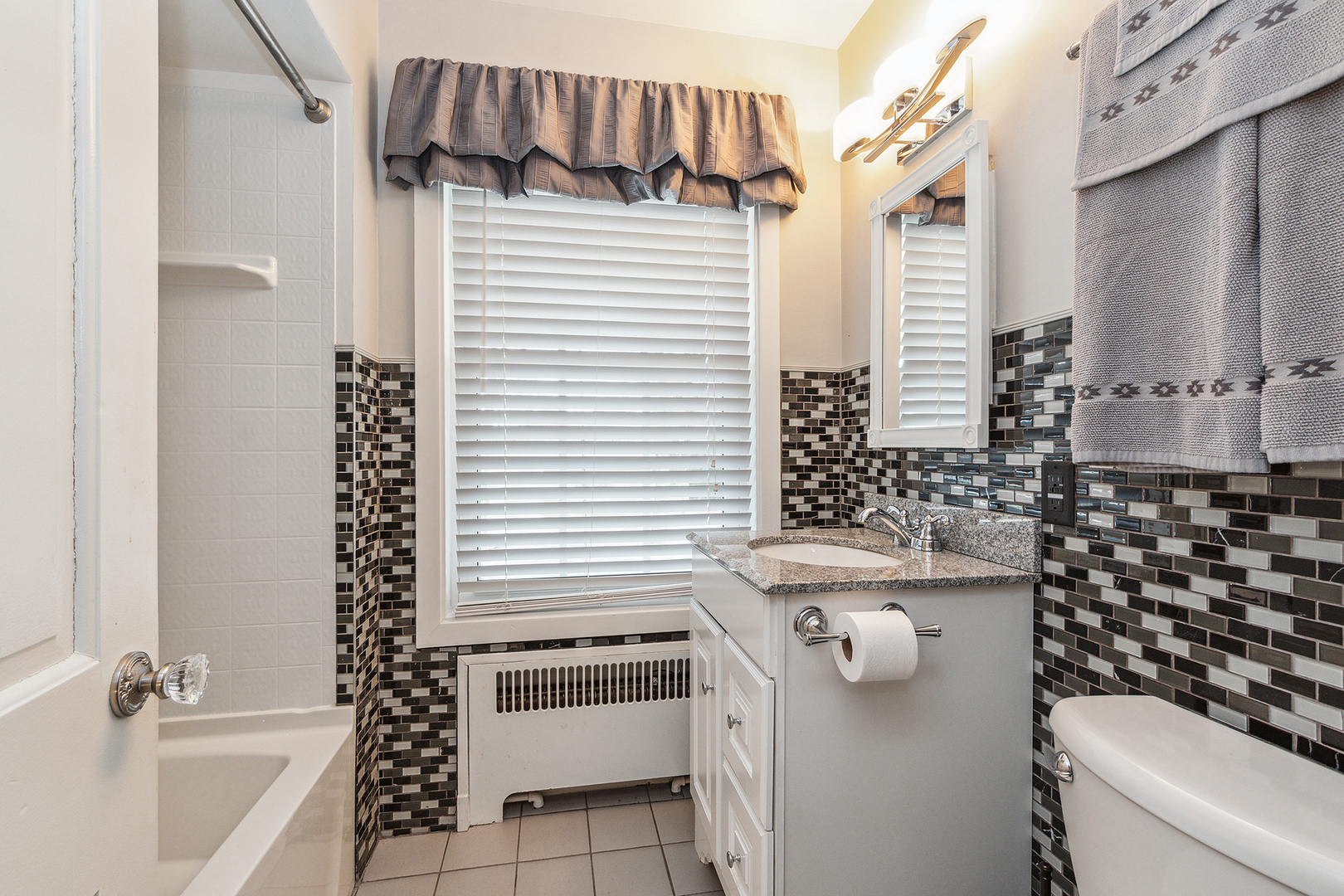 305 North Reed Street Joliet, IL 60435 - Photo 37 of 62 a bathroom with a sink toilet and shower