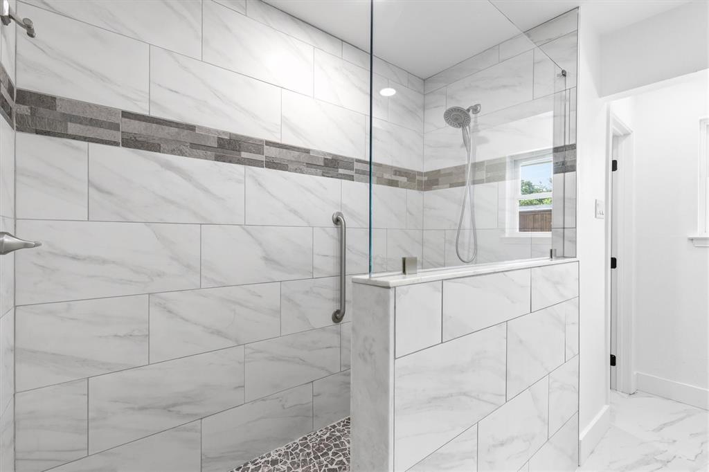 4446 Thunder Road Dallas, TX 75244 - Photo 15 of 30 Walk-in shower featuring a glass enclosure and a textured stone mosaic floor