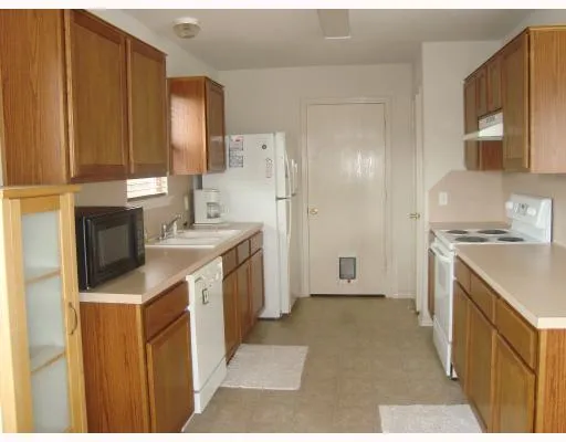 a kitchen with a sink stove and refrigerator