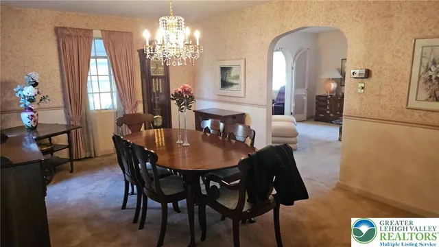 a view of a dining room with furniture and chandelier