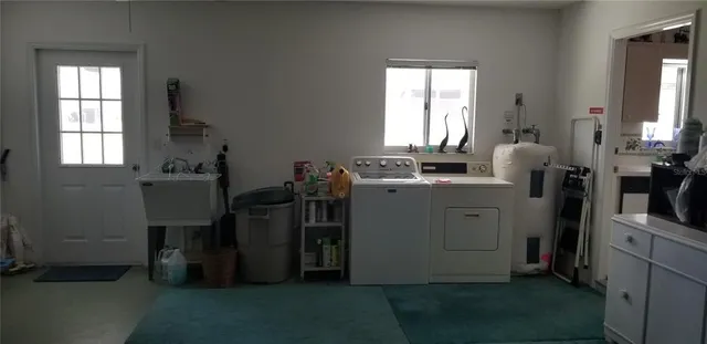 a view of a kitchen with fridge and workspace