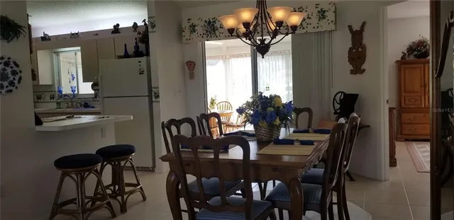 a view of a dining room with furniture and chandelier