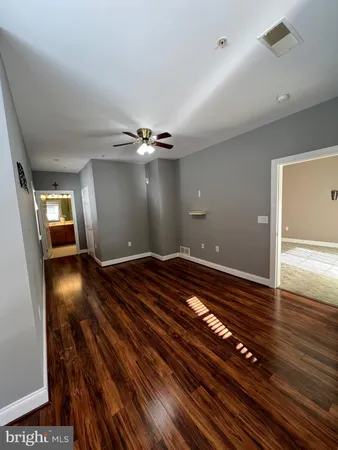 a view of an empty room and wooden floor
