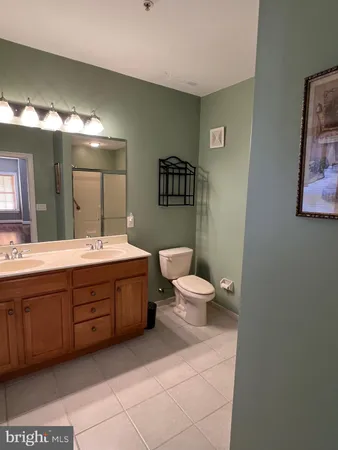 a spacious bathroom with a double vanity sink and a mirror