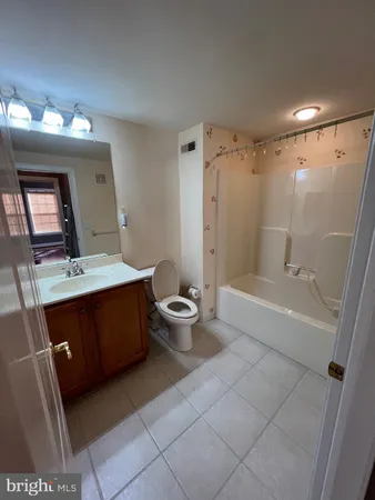 a bathroom with a double vanity sink toilet mirror and bathtub