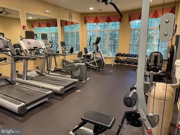 a room with gym equipment and large mirror