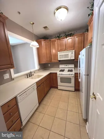 a kitchen with a stove sink and refrigerator