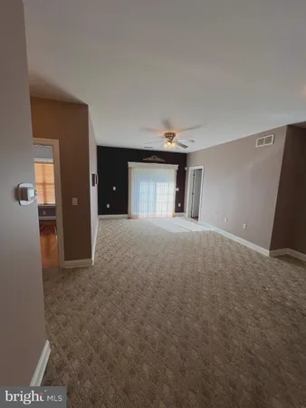 a view of a big room with closet and windows