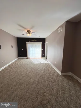 a view of an empty room with windows