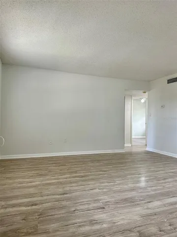 a view of an empty room and wooden floor