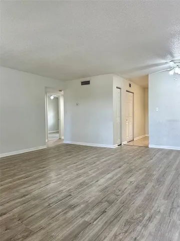 a view of an empty room and wooden floor