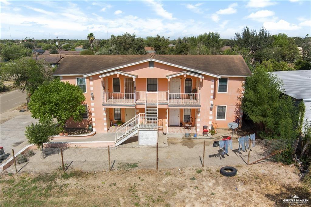 Rear view of house with stairs, covered porch, a fenced backyard, stucco siding, and a patio area