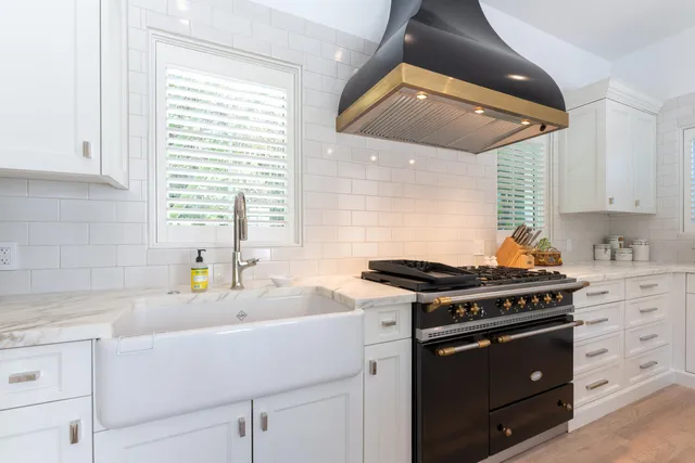 a kitchen with stainless steel appliances a stove sink and cabinets
