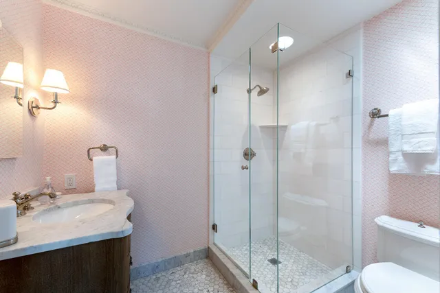 a bathroom with a granite countertop toilet a sink and a bathtub