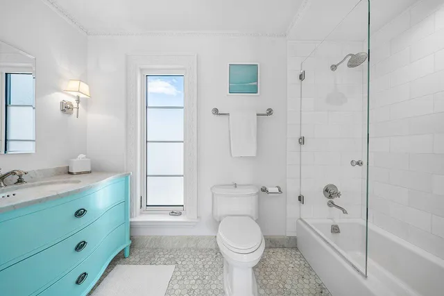 a spacious bedroom with a bed and wooden floor