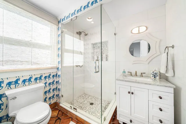 a bathroom with a tub sink and mirror