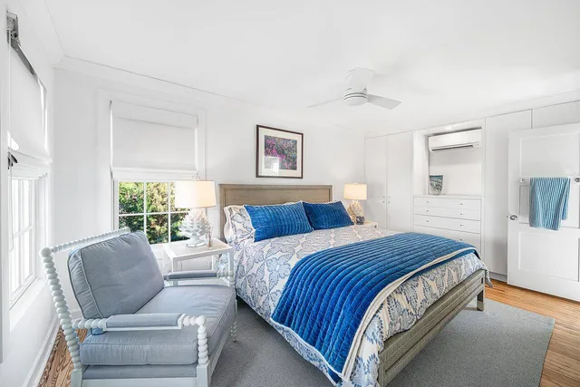 a view of a livingroom with chairs and a workspace