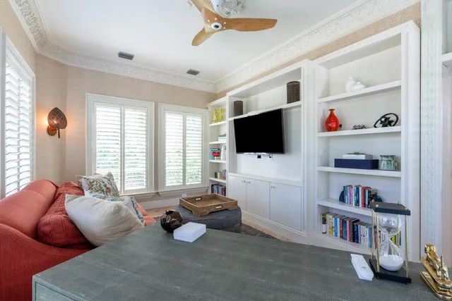 a living room with furniture flat screen tv and a window