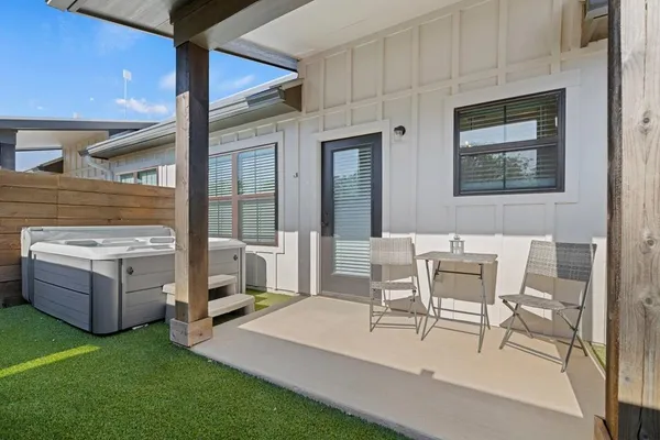 a view of an house with backyard porch and furniture