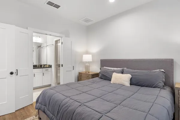 a bedroom with a bed and a night stand