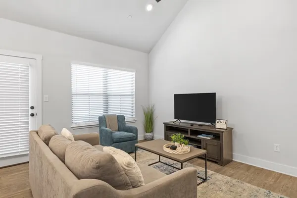 a living room with furniture and a flat screen tv
