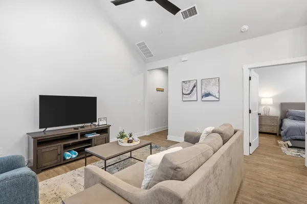 a living room with furniture and a flat screen tv