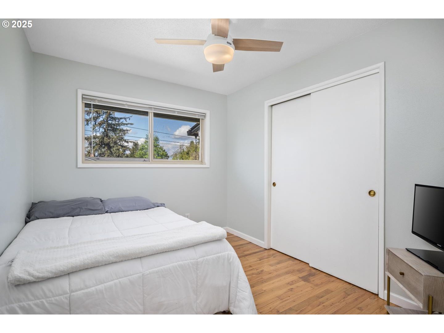 2000 Northwest 7th Place Gresham, OR 97030 - Photo 17 of 34 a bedroom with a bed and a flat screen tv