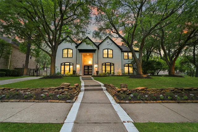 a front view of a house with a yard and outdoor seating