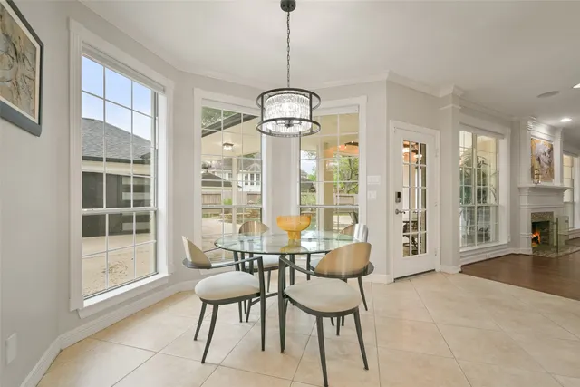 a dining room with furniture a chandelier and wooden floor