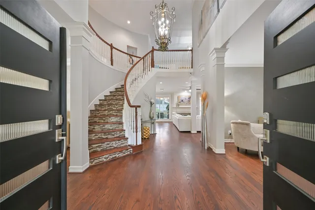 a view of entryway with wooden floor and stairs
